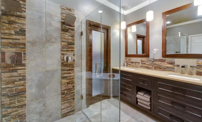 Norstone Ochre Blend Stacked Stone Rock Panels used as an accent strip on a bathroom vanity backsplash and inside a walk in shower